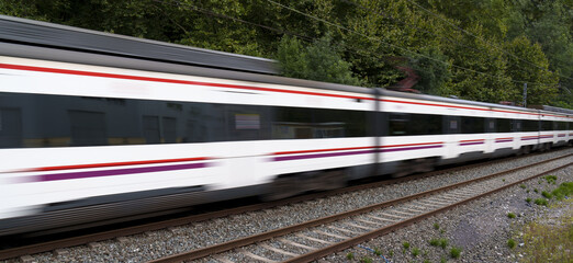 Train with passengers heads to the city at high speed. © poliki