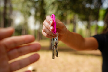 Close up of man and woman with house keys in a rural area