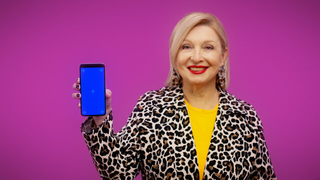 A senior woman is holding a smartphone with a pre-keyed screen, online shopping, discounts