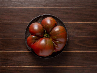 Ripe and large brown tomato, rich harvest