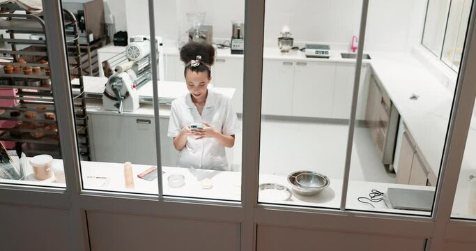 Phone, restaurant kitchen and woman chef working on baking, meal and social media scroll. Bakery, window above and rolling pin with a young female cook with dessert, cookies and order for cafe
