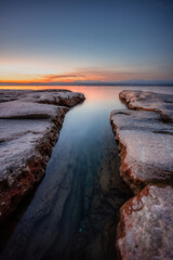 Fototapeta premium Beautiful landscape with lake and rocks at sunset. Lake Garda, Sirmione, Italy 