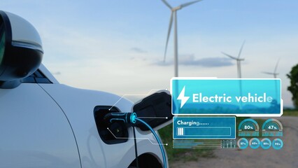 Electric car recharging energy from EV charging station display futuristic smart battery status hologram by EV charger plug cable in wind turbine farm. Alternative clean energy sustainability. Peruse