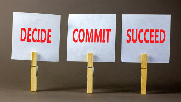 Decide commit succeed symbol. Concept word Decide Commit Succeed on beautiful white paper on wooden clothespin. Beautiful grey table grey background. Business decide commit succeed concept. Copy space