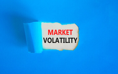 Market volatility symbol. Concept words Market volatility on beautiful white paper. Beautiful blue paper background. Business market volatility concept. Copy space.orange