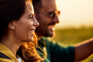 A close-up of a beautiful woman enjoying a quad bike drive with her boyfriend.