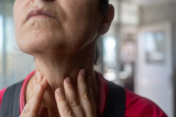 woman with thyroid gland problem at home, close up