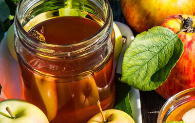 Close up with jar of honey, apples and small bee - symbols of Jewish sweet New Year holiday - Rosh...