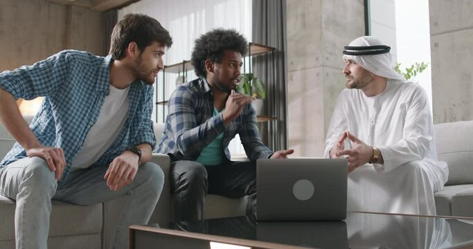 Young IT startup duo presents groundbreaking project to Arab investor. Cultural exchange, innovation in compelling footage. IT duo with passion enthusiasm presents compelling project to Arab investor