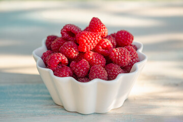 Fresh raspberries on a wooden  table 
