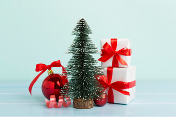 Miniature christmas tree with gift boxes and decor on table