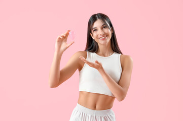 Fototapeta na wymiar Young woman with menstrual cup on pink background