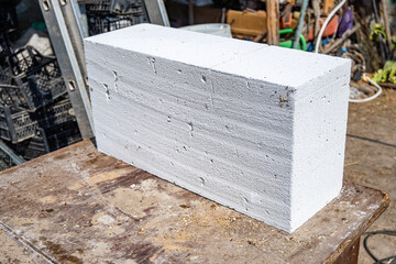 White aerated concrete block, brick close-up. Laying aerated concrete blocks. Construction of aerated concrete blocks, bricks.