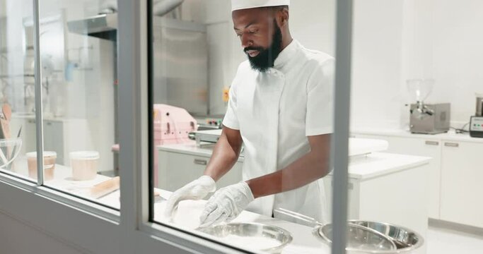 Man, chef and kneading dough on a restaurant kitchen counter for cooking job. Black person or professional baker working with food at work for pastry, pizza or baking recipe for a bakery or hotel