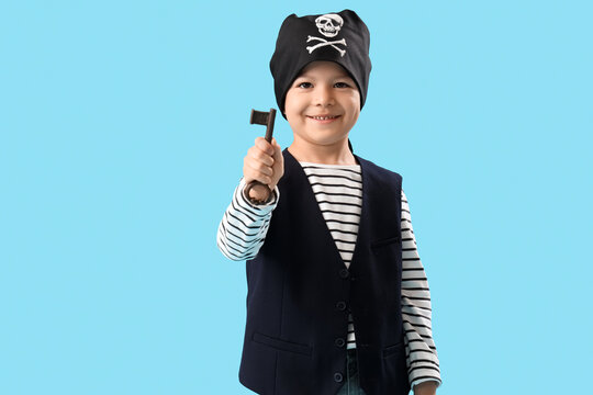 Cute little pirate with key on blue background