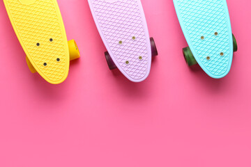 Set of skateboards on pink background