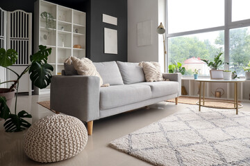 Interior of modern living room with grey sofa and coffee table