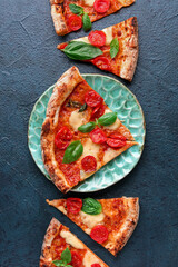 Plate with slices of tasty pizza Margarita on blue background