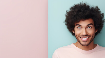 spanisch male model  in front of a pink and blue pastel background 
