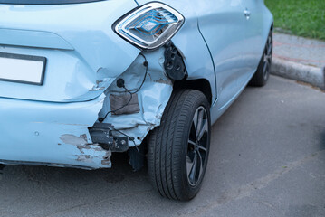 Fototapeta na wymiar Back side of blue color car big damaged and broken by accident on road. dented back hatch