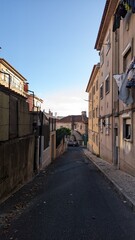 Fototapeta na wymiar A narrow street early in the morning in Lisbon without people