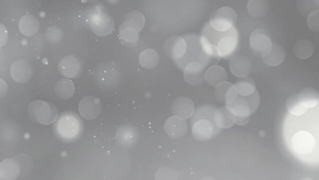 Abstract motion looped background with shimmering silver wind particles. Shimmering particles with bokeh.