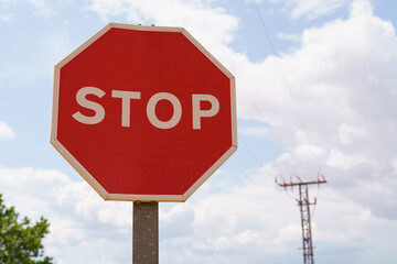 Close-up photo of a stop road sign against the sky