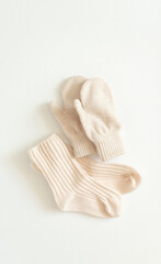 Set of baby accessories for spring, autumn or winter. Socks and gloves and rubber. Flat lay, top view