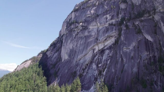 Aerial footage giant cliff rock formation, the Chief, Squamish, BC, beautiful Canadian outdoors, climbing wall, mountain. 4K 24FPS