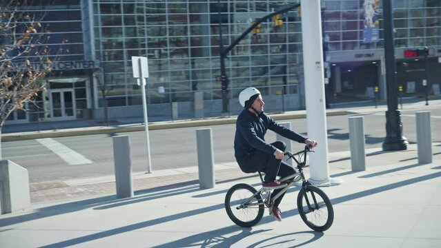 Wide - Bicyclist Standing On Moving Bike