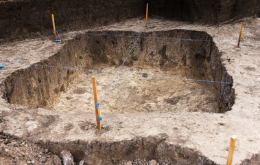 Archaeological work, archaeologists dug a hole in field to search for artifacts and finds