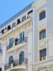 Classical old fashioned facades with elegant windows and balcony made in Portuguese architectural tradition. Vintage classy architecture in Lisbon, Portugal
