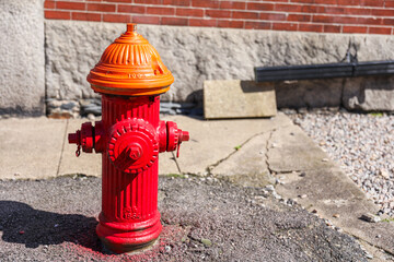 Fototapeta na wymiar fire hydrant is a vital urban sentinel, standing ready to combat flames with its vibrant red hue. Symbolizing safety and emergency response, this metal sentinel provides a lifeline for firefighters