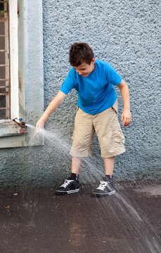 Boy playing with a jet of water