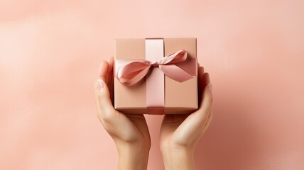 female hands delicately presenting a kraft paper gift box adorned with a satin ribbon bow. The image is set against a soft pastel background, allowing ample space for adding a personalized message.