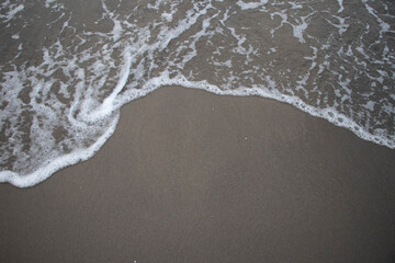 Fototapeta na wymiar Sea foam on the beach