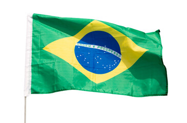On clear sunny day,national flag of Brazil flies against blue sky.Brazilian flag is flying on flagpole