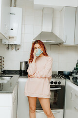 Young woman drink coffee in the kitchen