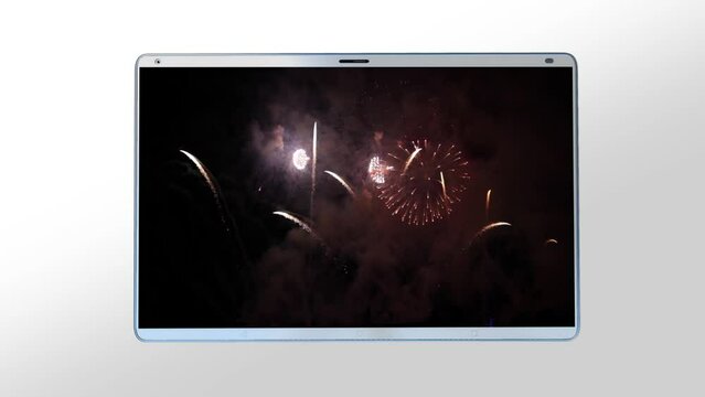 White tablet computer with fireworks on the screen on white background
