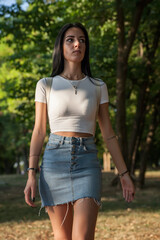 Girl in summer sunset walking in a park