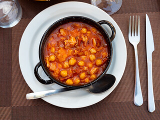 Hearty and satisfying dish callos of tripe simmered in broth with onions, garlic, tomatoes, and...