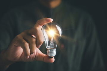 A businessman holding light bulb, concept of creativity and innovation. bright ideas and successful...