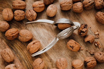 Walnuts Abundance and metal nutcracker in a bowl . Healthy food and snacks.Healthy fats. Keto diet...