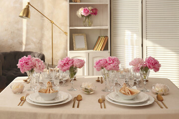 Stylish table setting with beautiful peonies and fabric napkins indoors