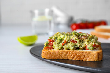 Delicious sandwich with guacamole on white table, closeup. Space for text