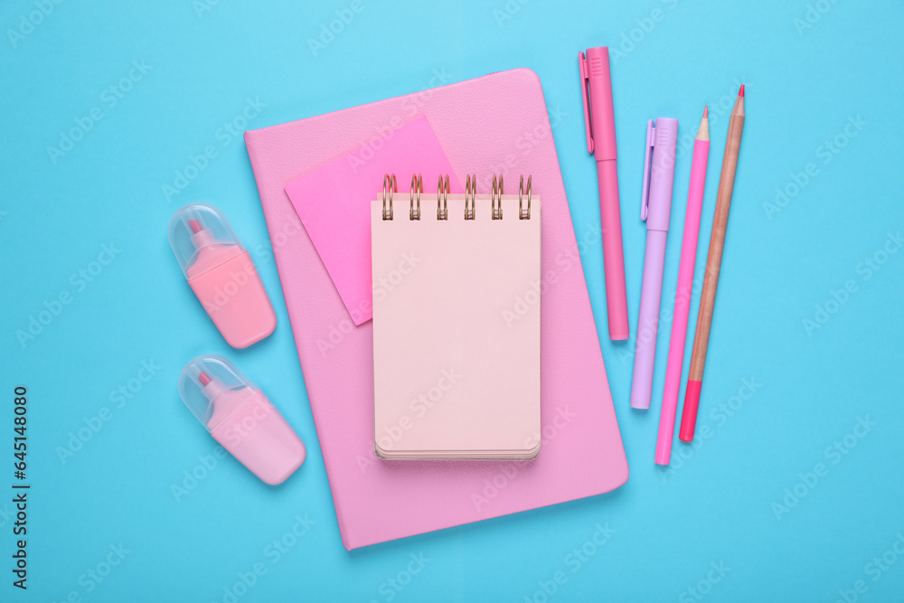 Poster Flat lay composition with pink notebooks and other school stationery on light blue background, space for text. Back to school