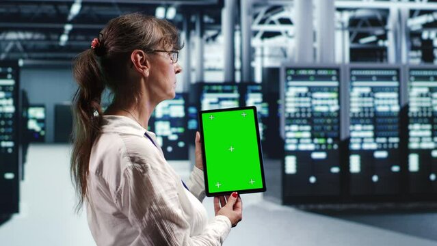 Senescent expert in servers facility housing high end processors capable of quickly and efficiently performing complex computations and data analysis, using mockup tablet to service hardware