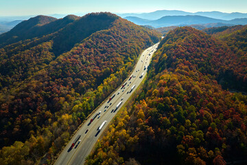 I-40 freeway road leading to Asheville in North Carolina over Appalachian mountain pass with yellow...