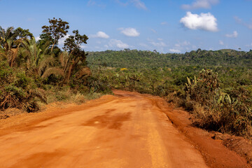 Driving on the famous earth road Transamazonica towards Santar&eacute;m through the Amazon rainforest in dry season in northern Brazil, South America