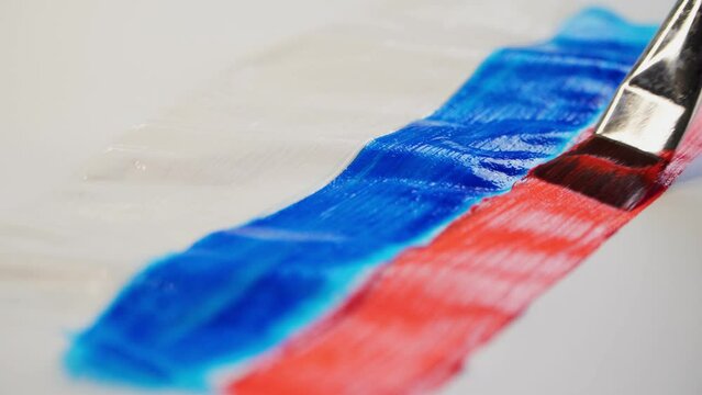 Drawing of the Russian flag in watercolor on a sheet of paper. Close-up.